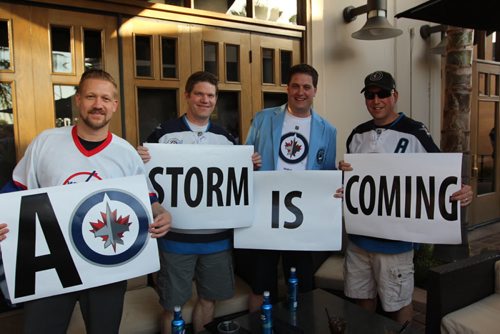 (From L-R) Derrick Wiebe, Darrell Harris, Mike Bayes and Dave Gill hold up their warning signs ahead of Game one.