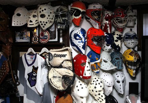 Brad Bayer makes goalie masks, not the combo mask-cage ones you see today, but the ones that Jason wore in Friday the 13th.  He thinks while the art work on the sides of masks is nice, it's so intricate that you can't recognize the goalie from the cheap seats like you could in the 70s and early 80s. He has a collection of more than 100 masks. He used to have more than 600 but he  sold a bunch off.. BORIS MINKEVICH/WINNIPEG FREE PRESS APRIL 17, 2015