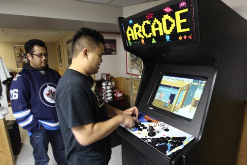 Nathaniel Calanza, right, with his friend Lester Pineda play a video game in his basement in St James  He is one of the co-organizers of this weekend's Retro Winnipeg Gamers convention-See David Sanderson story- Apr 20, 2015   (JOE BRYKSA / WINNIPEG FREE PRESS)