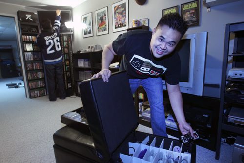 Nathaniel Calanza, right, with his friend Lester Pinedawith his piles of video games in his basement in St James  He is one of the co-organizers of this weekend's Retro Winnipeg Gamers convention-See David Sanderson story- Apr 20, 2015   (JOE BRYKSA / WINNIPEG FREE PRESS)