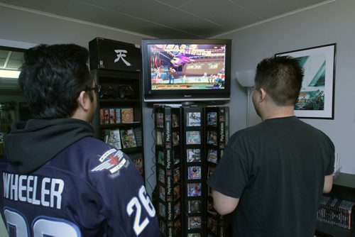 Nathaniel Calanza, right, with his friend Lester Pineda play a video game in his basement in St James  He is one of the co-organizers of this weekend's Retro Winnipeg Gamers convention-See David Sanderson story- Apr 20, 2015   (JOE BRYKSA / WINNIPEG FREE PRESS)