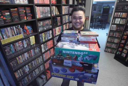 Nathaniel Calanza with his piles of video games in his basement in St James  He is one of the co-organizers of this weekend's Retro Winnipeg Gamers convention-See David Sanderson story- Apr 20, 2015   (JOE BRYKSA / WINNIPEG FREE PRESS)