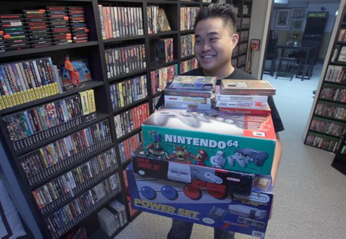 Nathaniel Calanza with his piles of video games in his basement in St James  He is one of the co-organizers of this weekend's Retro Winnipeg Gamers convention-See David Sanderson story- Apr 20, 2015   (JOE BRYKSA / WINNIPEG FREE PRESS)