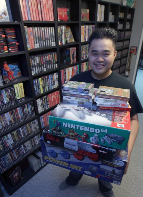 Nathaniel Calanza with his piles of video games in his basement in St James  He is one of the co-organizers of this weekend's Retro Winnipeg Gamers convention-See David Sanderson story- Apr 20, 2015   (JOE BRYKSA / WINNIPEG FREE PRESS)