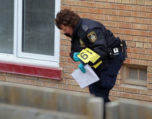 NEWS - A homicide investigation is ongoing after a man died from gunshot wounds early Monday morning on Highfield Street in Norwood Flats. Here the forensics investigation team works the back lane by the condos. BORIS MINKEVICH/WINNIPEG FREE PRESS APRIL 20, 2015