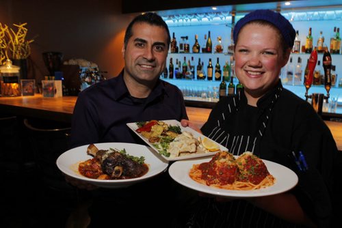 ENT - REST REVIEW - Bellissimo Restaurant & Lounge. L-R Owner Greg Gagliardi and Chef Jessica Cuthbert pose with L-R Lamb shank , Lemon veal scallopini, Spaghetti with veal meatballs. BORIS MINKEVICH/WINNIPEG FREE PRESS APRIL 20, 2015