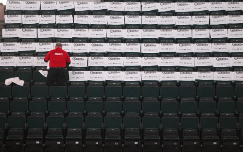 Event staff place white towels on each of the seats prior the to third game of the Stanley Cup playoff series between the Winnipeg Jets and the Anaheim Ducks at MTS Centre in Winnipeg, Manitoba. 150420 - Monday, April 20, 2015 -  (MIKE DEAL / WINNIPEG FREE PRESS)