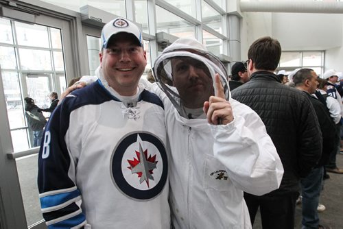 Jason Darragh (left) and Kasey Riddell (right) in a beekeeper suit arrive prior the to third game of the Stanley Cup playoff series between the Winnipeg Jets and the Anaheim Ducks at MTS Centre in Winnipeg, Manitoba. 150420 - Monday, April 20, 2015 -  (MIKE DEAL / WINNIPEG FREE PRESS)