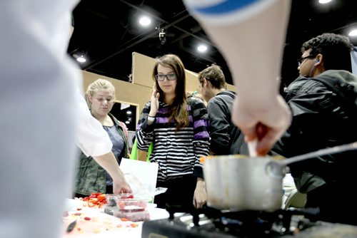 Students line up to receive homemade tarts from trade students in the culinary arts class at the Manitoba Institute for Trades and Technology  during the 18th annual Rotary Club Career Symposium at the RBC Convention Centre Tuesday.   Standup photo   Ruth Bonneville / Winnipeg Free Press April 21, 2015