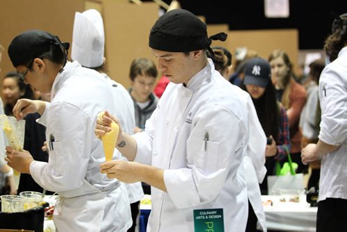 Eric Little, a first year student in the culinary arts class at the Manitoba Institute for Trades and Technology College, makes tarts for high school students visiting his booth during the 18th annual Rotary Club Career Symposium at the RBC Convention Centre Tuesday.   Standup photo   Ruth Bonneville / Winnipeg Free Press April 21, 2015