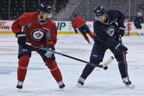 Winnipeg Jets' Toby Enstrom (39) and Bryan Little (18) during the morning pre-game skate at MTS Centre. The Jets will face-off against the Anaheim Ducks in the fourth game of their Stanley Cup playoff series tonight.   150422 April 22, 2015 Mike Deal / Winnipeg Free Press