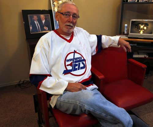 Rod Palson, the man behind the White Out with the old Jets is like a proud father these days. Rod Palson took his son on Monday and he's taking his daughter tonight. In the photo he's wearing his jersey from the old days. Here he poses in his old arena jets seats that someone gave to him as a gift. BORIS MINKEVICH/WINNIPEG FREE PRESS APRIL 22, 2015