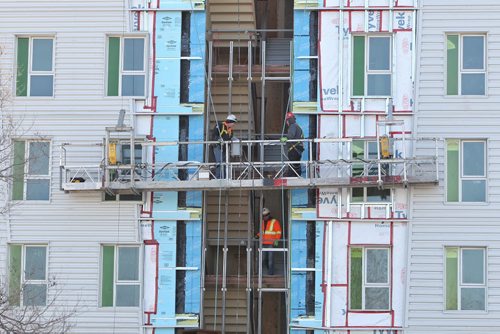 Construction continues on the apartment building at the southeast corner of Isabel Street and Pacific Avenue Thursday morning.  150423 April 23, 2015 Mike Deal / Winnipeg Free Press