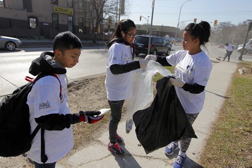 LOCAL - Over 350 students and staff from West End schools General Wolfe, Isaac Brock and Gordon Bell will help fill hundreds of bags full of garbage and recyclables from walkways, boulevards and parks and sweep dozens of west end sidewalks. They actively contribute to improving the look of their community and learn what goes down, someone has to pick up! The annual Sweep Off makes a significant impact on West End neighbourhoods as they are relieved of a winters worth of accumulated debris. Outfitted in white T-shirts, the students will be hard to miss and will be on the streets from 10 am until 3pm. These are students from General Wolfe junior high and hit the streets at Maryland and Sargent. The students in this photo are l-r Raven Manalastas, 14, Sarah Ybid,14, and Leatitia Ladera,15. BORIS MINKEVICH/WINNIPEG FREE PRESS APRIL 23, 2015