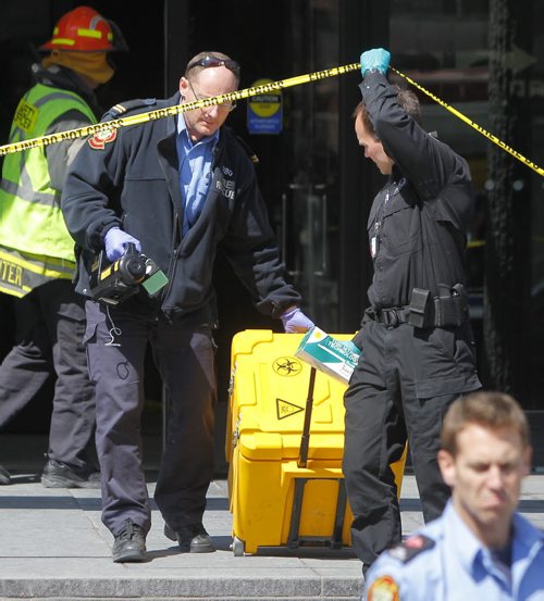 Haz Mat scene at 363 Broadway. The suspicious package was brought out in this yellow case. BORIS MINKEVICH/WINNIPEG FREE PRESS APRIL 23, 2015