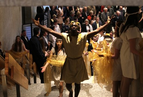 Dancers dressed in Greek influenced costumes lead the way for special guests up the stairs to the opening of the Olympus exhibit for a private viewing Thursday evening.    Ruth Bonneville / Winnipeg Free Press April 23, 2015