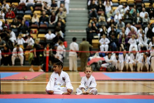 Two young students wait for their turn to compete at the Can-Am Games Taekwondo Tournament inside Investors Group Athletic Centre at the University of Manitoba, Saturday, April 25, 2015. (TREVOR HAGAN/WINNIPEG FREE PRESS)