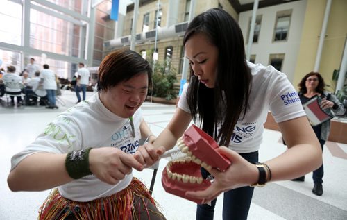 University of Manitoba Dentistry student, Jeanne Trinh, right, with David Cho, during the second annual Oral Health Total Healths sharing Smiles Day where students work with people with disabilities at the Bannatyne Campus, Saturday, April 25, 2015. (TREVOR HAGAN/WINNIPEG FREE PRESS)