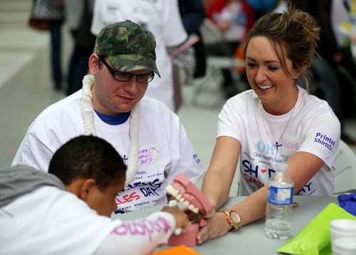 University of Manitoba Dentistry student, Nicole Wotton, right, teaching Beth Falade and Thomas Henry proper brushing technique during the second annual Oral Health Total Healths sharing Smiles Day where students work with people with disabilities at the Bannatyne Campus, Saturday, April 25, 2015. (TREVOR HAGAN/WINNIPEG FREE PRESS)