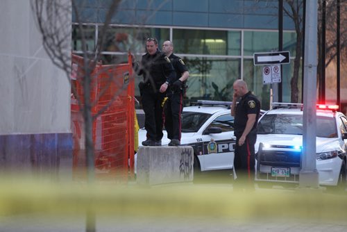Police officers investigate the suspicious death of a person found behind the APTN building between Hargrave and Carlton Street Saturday evening.  Officers could be seen going in and out of the APTN building to review security camera's mounted on the back of their building.   Hargrave St.  is closed to all traffic between Portage Ave. and Ellice Ave.  Standup photo.    Ruth Bonneville / Winnipeg Free Press April 25, 2015