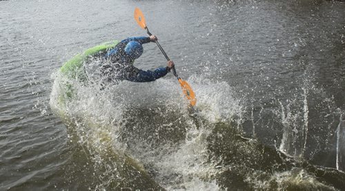 150426 DAVID LIPNOWSKI / WINNIPEG FREE PRESS  Steven Walker of the Manitoba Whitewater Club performs tricks in his kayak after sliding down the toboggan slide Sunday April 26, 2015 at FortWhyte Alive for the Earth Day Celebration.