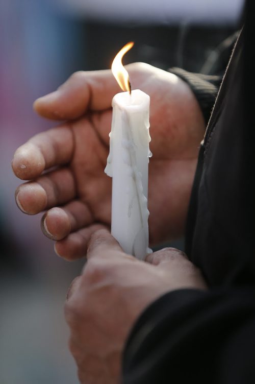 April 26, 2015 - 150426  -   People gather Sunday, April 26, 2015 on Carlton between Portage and Ellice for a vigil for two men killed . John Woods / Winnipeg Free Press