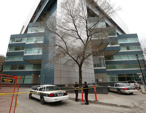 Winnipeg Police at the taped off scene Monday morning in a lot off of Hargrave St. behind the Air Canada building. Police said Sunday the body of a man in his late 60s had been found in the east lane of 329 Hargrave St. on Saturday at about 12:45 a.m., and the body of a man in his late 40s was discovered behind 333 Portage Ave. at about 6:30 p.m. Wayne Glowacki / Winnipeg Free Press April 27 2015