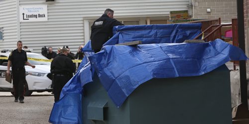Winnipeg Police at the loading docks behind the Siloam Mission Monday morning prior to the garbage bins being taken away. Wayne Glowacki / Winnipeg Free Press April 27 2015