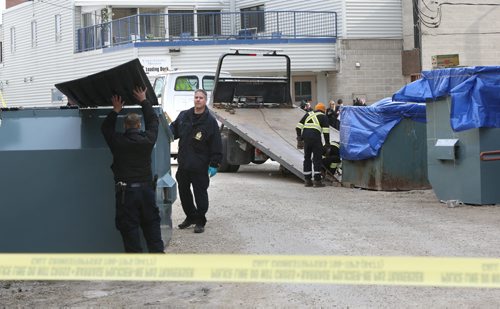 Winnipeg Police at the loading docks behind the Siloam Mission Monday morning as the garbage bins are being loaded. Wayne Glowacki / Winnipeg Free Press April 27 2015