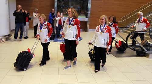 Winnipeg James Armstrong Richardson International Airport - Team Lois Fowler, senior women's world curling champions, arrive home after competition in Sochi, Russia. Left to right - Lois Fowler (Fourth, Skip), Maureen Bonar (Third, Vice-Skip), Cathy Gauthier (Second), Allyson Stewart (Lead)(behind Gauthier. BORIS MINKEVICH/WINNIPEG FREE PRESS APRIL 27, 2015