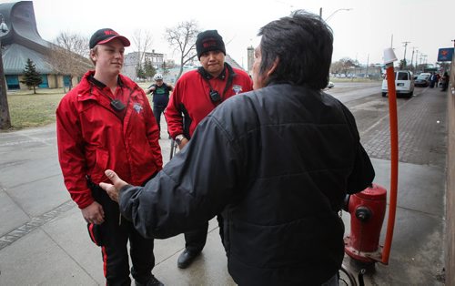 Downtown BIZ watch volunteers, Tanner Magalas (left) and Robert Catagas (right) chat with a homeless man outside the Salvation Arm building on Main Street. 150427 - Monday, April 27, 2015 -  (MIKE DEAL / WINNIPEG FREE PRESS)