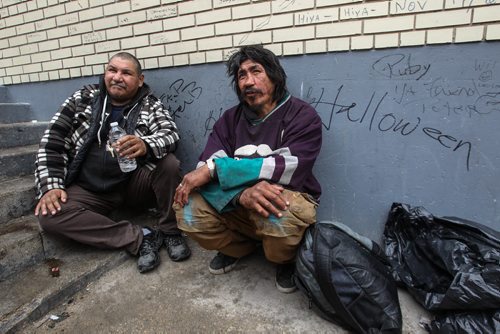 In a back alley close to Main Street and Higgins Avenue, cousins, Doug Ballantyne (left) and Peter Blackhawk (right) talk about looking out for each other and others as a daily part of life on the street. 150427 - Monday, April 27, 2015 -  (MIKE DEAL / WINNIPEG FREE PRESS)