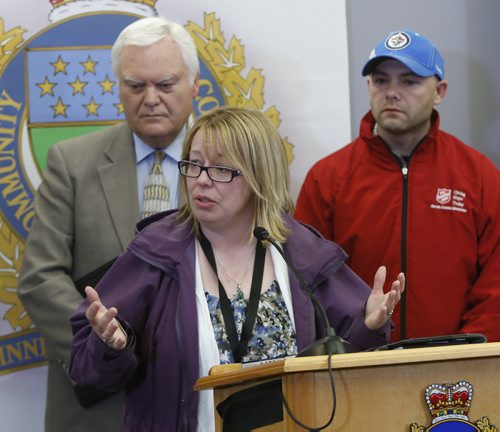 At podium,  Lisa Goss, Executive Director of the Main St. Project,   Jim Hayes,  Executive Consultant at left and Mark Stewart, Residential Manager both with the Salvation Army, Booth Centre spoke to reporters after the Winnipeg Police news conference Tuesday at the PSB regarding the recent homicide investigations. Bart Kives /Gord Sinclair stories  Wayne Glowacki / Winnipeg Free Press April 28 2015