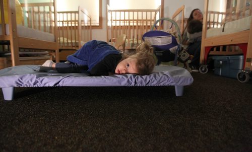 49.8   Feature photos on Early Childhood Educators working with kids at Splash Child Enrichment Centre on McGregor Street.  Young Mia lies on her cot in the infant room during nap time at the centre.  See Mary Agnes Welch story.   Ruth Bonneville / Winnipeg Free Press April 28, 2015