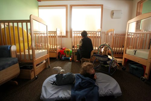 49.8   Feature photos on Early Childhood Educators working with kids at Splash Child Enrichment Centre on McGregor Street. Early Childhood Educator Melchora Macario assists infants to fall asleep during afternoon nap time.  See Mary Agnes Welch story.   Ruth Bonneville / Winnipeg Free Press April 28, 2015