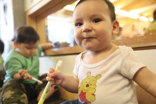 49.8   Feature photos on Early Childhood Educators working with kids at Splash Child Enrichment Centre on McGregor Street.  Young infant smiles while brushing his teeth after lunch.  See Mary Agnes Welch story.   Ruth Bonneville / Winnipeg Free Press April 28, 2015
