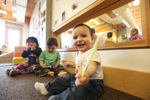 49.8   Feature photos on Early Childhood Educators working with kids at Splash Child Enrichment Centre on McGregor Street. Young infant giggles as he tries to brush his teeth after eating. See Mary Agnes Welch story.   Ruth Bonneville / Winnipeg Free Press April 28, 2015