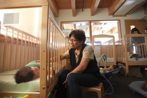 49.8   Feature photos on Early Childhood Educators working with kids at Splash Child Enrichment Centre on McGregor Street. Early Childhood Educator Melchora Macario assists infants to fall asleep during afternoon nap time.  See Mary Agnes Welch story.   Ruth Bonneville / Winnipeg Free Press April 28, 2015