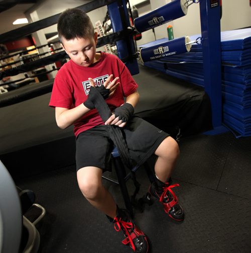 Young protoge of Roland Vandal, Zack O'Grady wraps his hands beofre a workout at Elite Gym where Vandal trains his boxers. See Geoff Kirbyson story re:boxer turned author. April 28, 2015 - (Phil Hossack / Winnipeg Free Press)