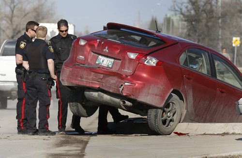 Winnipeg Police at the scene of a vehicle collision near the entrance to their West District Police Station Wednesday morning delaying West bound traffic on Grant Ave. Wayne Glowacki / Winnipeg Free Press April 29 2015