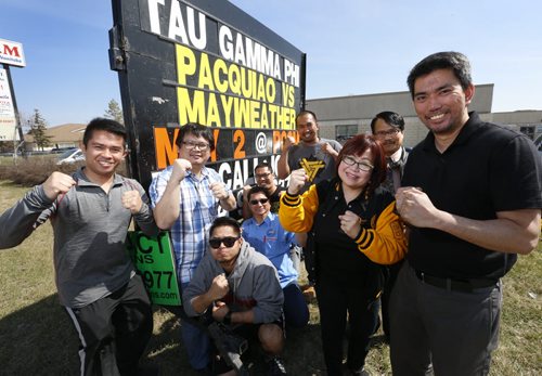 At right, Jomar Guaring pres. of the Tau Gamma Phi Fraternity with members by the sign advertising Saturdays Pacquiao Las Vegas bout to be shown at the Philippine Canadian Centre of Manitoba. The Filipino fraternity is organizing it to raise money for scholarship  the $20 tix include viewing the fight and a Filipino feast. Carol Sanders story Wayne Glowacki / Winnipeg Free Press April 29 2015