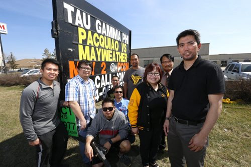 At right, Jomar Guaring pres. of the Tau Gamma Phi Fraternity with members by the sign advertising Saturdays Pacquiao Las Vegas bout to be shown at the Philippine Canadian Centre of Manitoba. The Filipino fraternity is organizing it to raise money for scholarship  the $20 tix include viewing the fight and a Filipino feast. Carol Sanders story Wayne Glowacki / Winnipeg Free Press April 29 2015