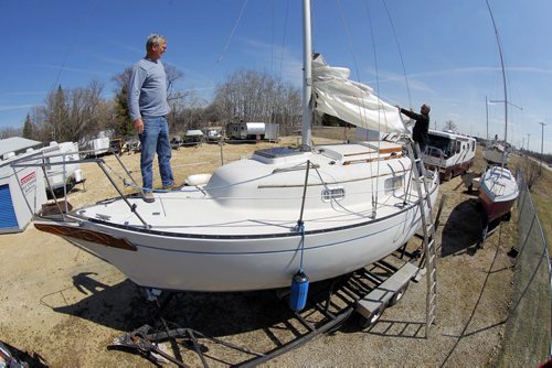 L-R Sailboat owner Glen Pollard and his friend Russ Isfeld, owner of Solshine, a business that services sailboats/storage, work on Pollard's boat in Gimli. The Marina opens on May 1st and the ice is well away from shore now. Summer is almost here... BORIS MINKEVICH/WINNIPEG FREE PRESS APRIL 29, 2015