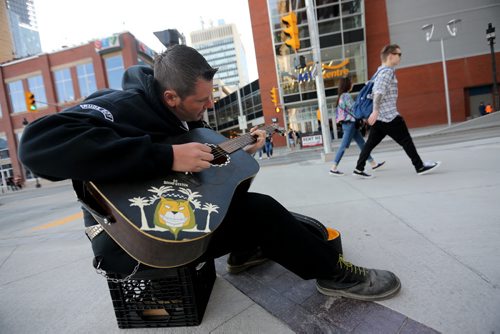 Alex Dechoiseul busks at MTS Centre before the Def Leppard concert, Wednesday, April 30, 2015. Photographers are not allowed inside the venue to cover tonights show. (TREVOR HAGAN/WINNIPEG FREE PRESS)