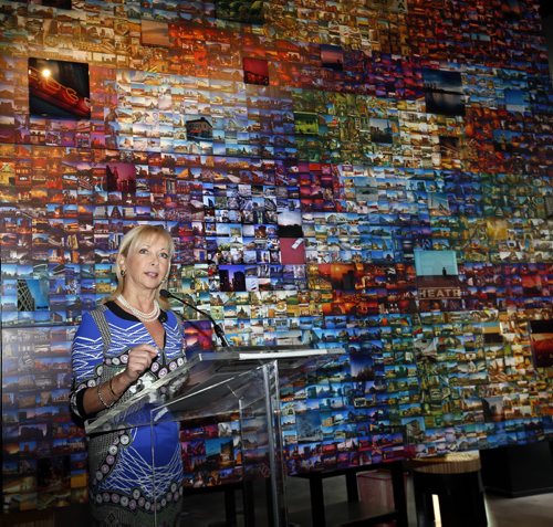 Christiane Germain, co-president of Groupe Germain Hotels at the official opening Thursday of the Alt Hotel at Centrepoint across from the MTS Centre on Portage Ave. She is at the podium in the lobby in front of an art installation composed of 2500 Winnipeg photographs by artist Bryan Scott.  Martin Cash story Wayne Glowacki / Winnipeg Free Press April 30 2015