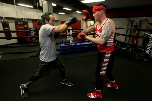 Boxer Jim Agapito and his coach/club owner, Kent Brown, at Elite Boxing MMA, Thursday, April 29, 2015. (TREVOR HAGAN/WINNIPEG FREE PRESS)