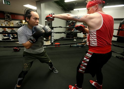 Boxer Jim Agapito and his coach/club owner, Kent Brown, at Elite Boxing MMA, Thursday, April 29, 2015. (TREVOR HAGAN/WINNIPEG FREE PRESS)