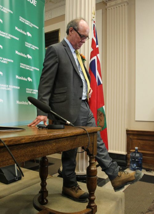 NDP Finance Minister Greg Dewar shows off his work-boots before he presents the 2015 Provincial Budget to the media prior to presenting to the provincial assembly Thursday afternoon. 150430 - Thursday, April 30, 2015 -  (MIKE DEAL / WINNIPEG FREE PRESS)