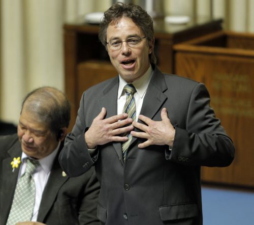 Manitoba's new finance minister presented his first budget in Winnipeg on Thursday afternoon. In this photo new Interlake MLA Thomas Nevakshonoff, right, reacts to his first ever question in the house. BORIS MINKEVICH/WINNIPEG FREE PRESS APRIL 30, 2015