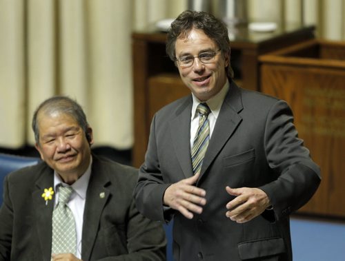 Manitoba's new finance minister presented his first budget in Winnipeg on Thursday afternoon. In this photo new Interlake MLA Thomas Nevakshonoff, right, reacts to his first ever question in the house. BORIS MINKEVICH/WINNIPEG FREE PRESS APRIL 30, 2015